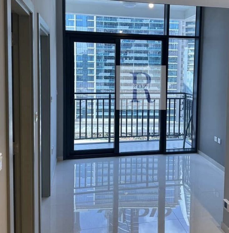 Living room with floor-to-ceiling glass doors to the balcony, 1BR apartment in Zada Tower